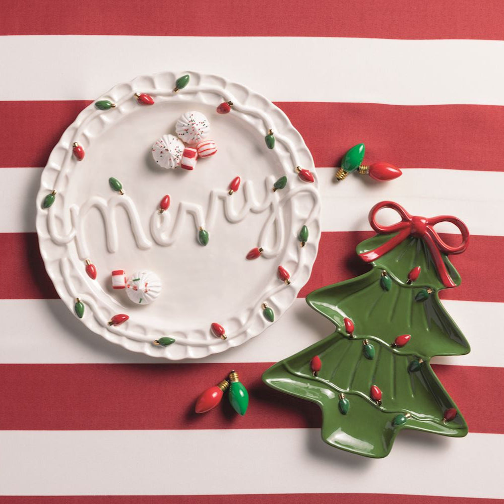 Decorative Christmas-themed plate and tree ornament on a red and white striped background