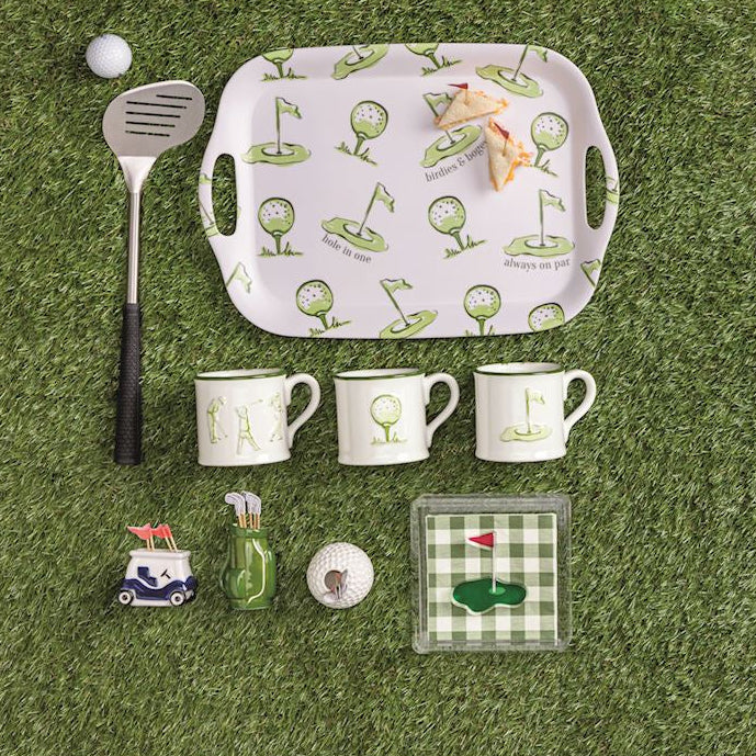 Golf-themed tableware set on a grassy background