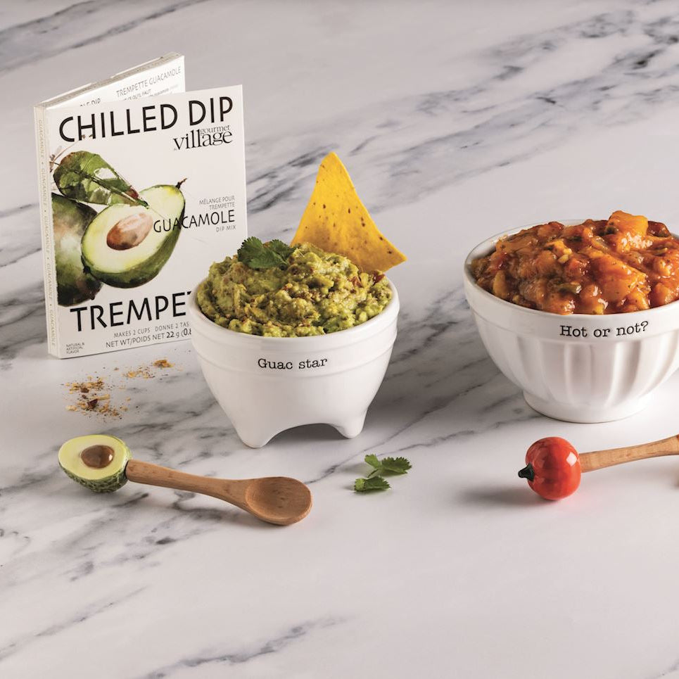 Assorted Mexican food items including salsa, guacamole, and tortilla chips on a marble surface.