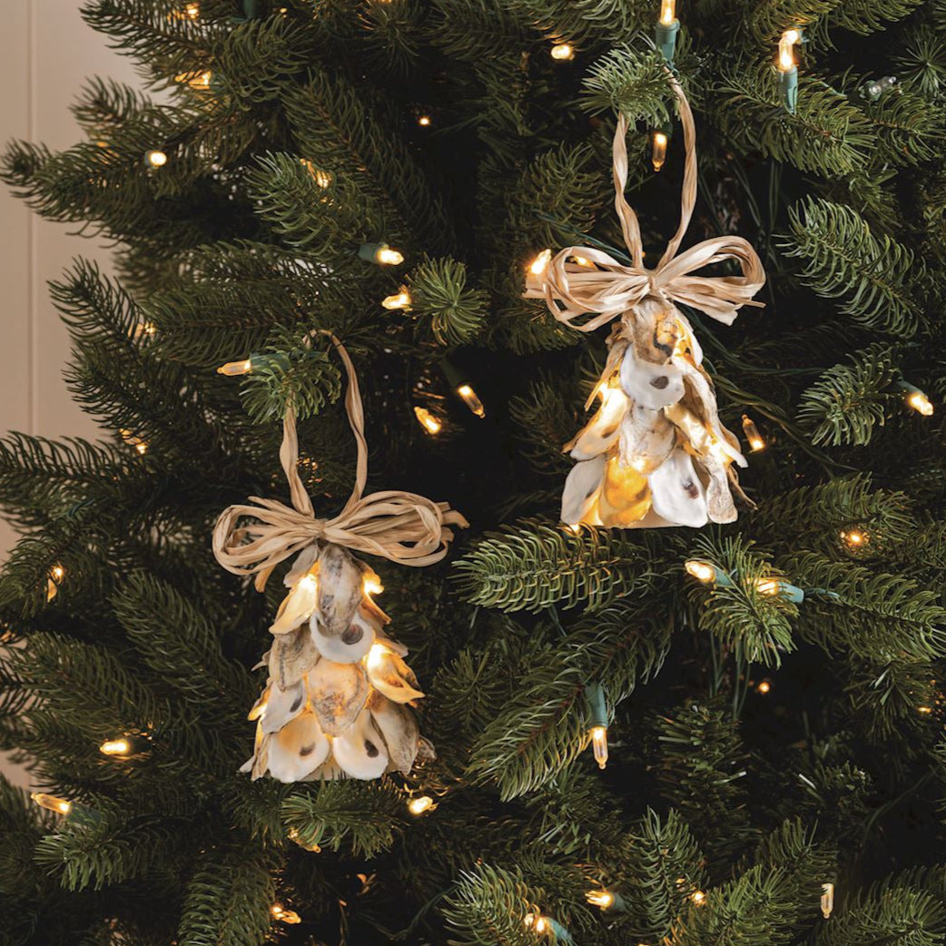 Decorative angel ornaments with lights on a Christmas tree.