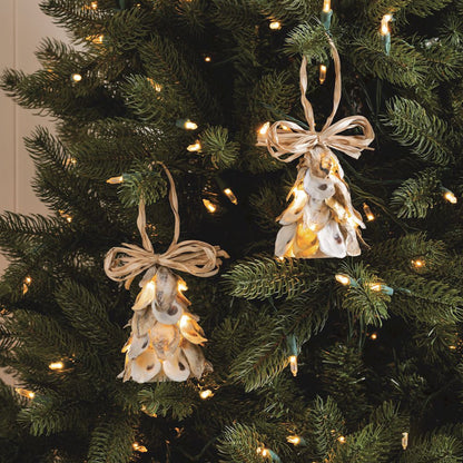 Decorative angel ornaments with lights on a Christmas tree.