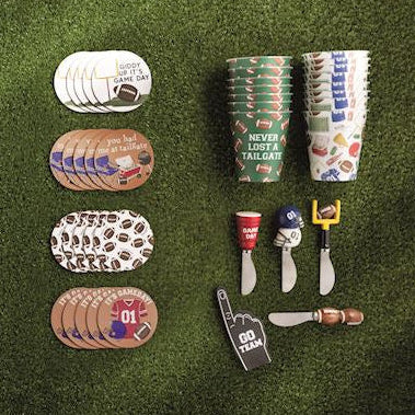 Collection of football-themed party supplies on a grass-like surface