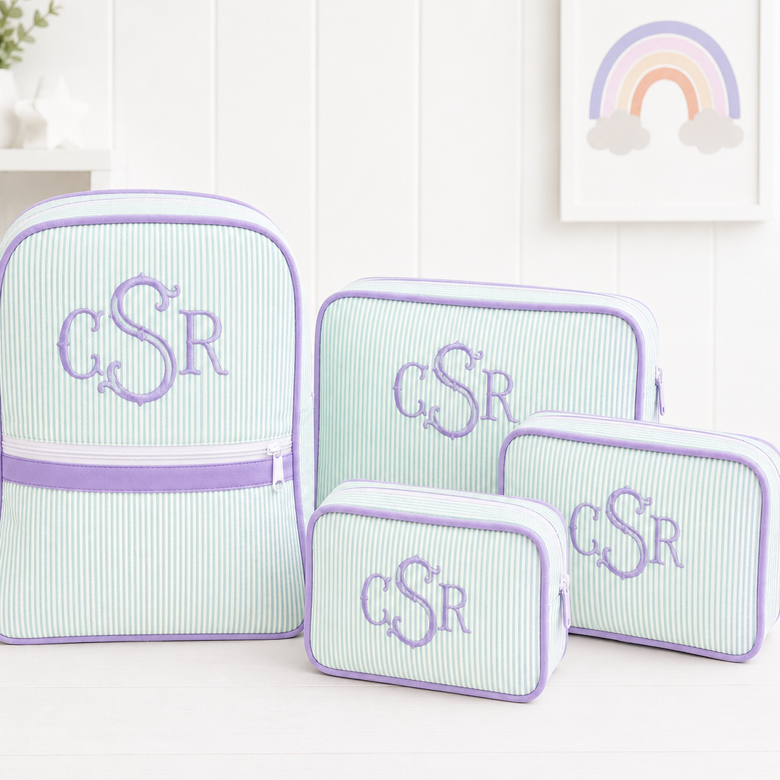 Set of four mesh bags with monogram 'CSR' on a white surface.