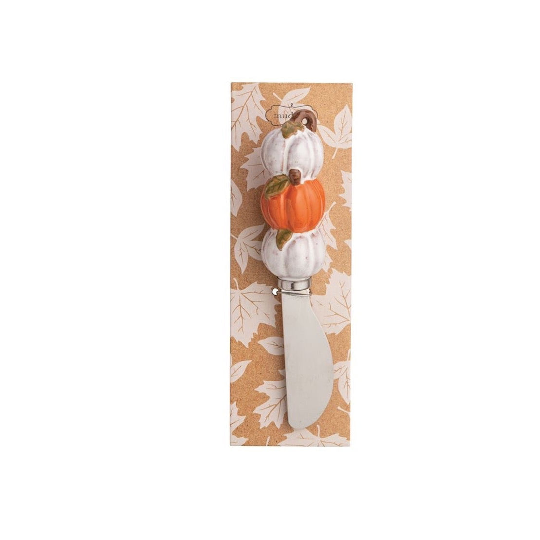 A decorative cheese knife with a white handle featuring a small orange pumpkin and white gourds, mounted on a tan card with a white leaf pattern, set against a plain white background.
